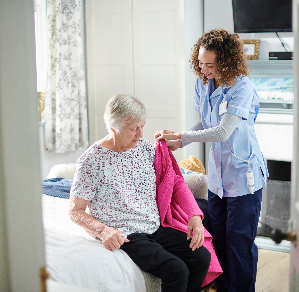 caregiver assisting elderly with personal care